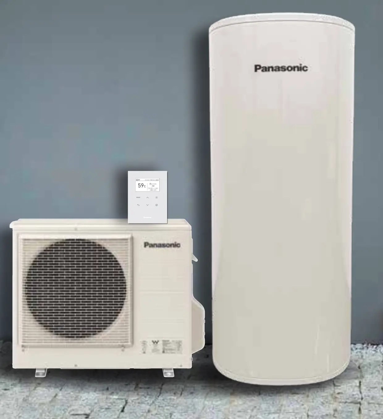 A Panasonic CO₂ heat pump hot water system standing against a grey rendered wall on paving: a low wide outdoor unit with a large circular fan grille on the left, a small wall-mounted controller above it showing 59°C, and a tall cream cylindrical storage tank on the right, both units marked Panasonic